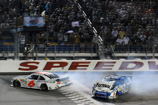 Ricky Stenhouse Jr., driver of the No. 6 RickyvsTrevor.com Ford crosses the finish line to win, ahead of Carl Edwards, driver of the No. 60 Fastenal Ford, after colliding on the final lap during the NASCAR Nationwide Series U.S. Cellular 250 at Iowa Speedway on Aug. 6 in Newton, Iowa. (Credit: Jason Smith/Getty Images for NASCAR)