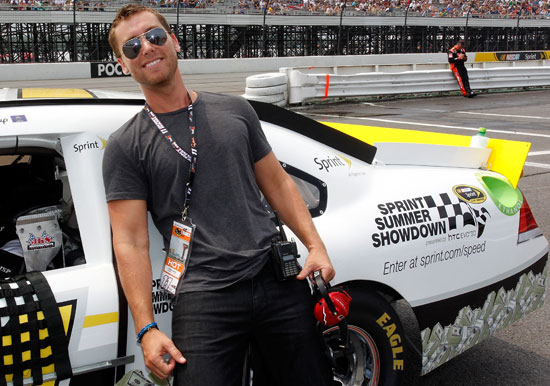 Singer Lance Bass, member of the boy band NSYNC, stands by the Sprint Summer Showdown car during the NASCAR Sprint Cup Series Good Sam RV Insurance 500 at Pocono Raceway on Aug. 7 in Long Pond, Pa. (Credit: Geoff Burke/Getty Images for NASCAR)