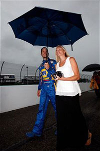 Martin Truex Jr., driver of the #56 NAPA Auto Parts Toyota, walks off the grid with his girlfriend Sherry Pollex as it starts to rain before the NASCAR Sprint Cup Series Heluva Good! Sour Cream Dips at the Glen at Watkins Glen International on August 14, 2011 in Watkins Glen, New York. (Photo by Chris Graythen/Getty Images) 