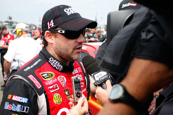 Tony Stewart, driver of the No. 14 Office Depot/Mobil 1 Chevrolet, speaks to the media on the grid after qualifying for the NASCAR Sprint Cup Series Heluva Good! Sour Cream Dips at the Glen at Watkins Glen International on Aug. 13 in Watkins Glen, N.Y. (Credit: Jeff Zelevansky/Getty Images for NASCAR)