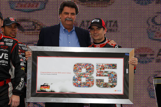 NASCAR President Mike Helton presents a plaque to Jeff Gordon commemorating his 85th win in the NASCAR Sprint Cup Series AdvoCare 500 at Atlanta Motor Speedway on Sept. 6 in Hampton, Ga. (Credit: Chris Graythen/Getty Images)