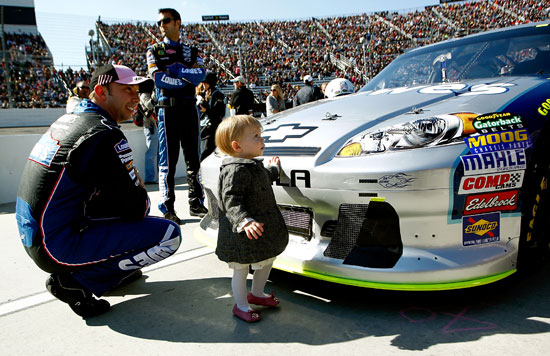No. 48 crew chief Chad Knaus spends time with Genevieve Marie Johnson, the daughter of his driver five-time NASCAR Sprint Cup Series champion Jimmie Johnson, before the TUMS Fast Relief 500 at Martinsville Speedway on Sunday. (Credit: Jeff Zelevansky/Getty Images for NASCAR)