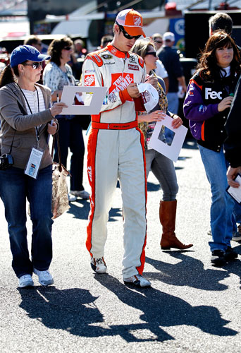 Joey Logano, driver of the No. 20 The Home Depot Toyota, signs autographs during practice for the NASCAR Sprint Cup Series Good Sam Club 500 at Talladega Superspeedway on Oct. 21 in Talladega, Ala. (Credit: Jeff Zelevansky/Getty Images for NASCAR)