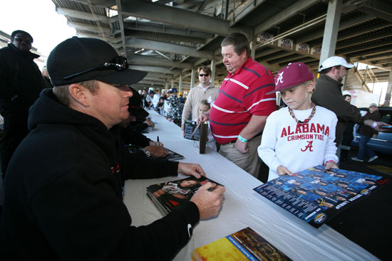 NASCAR Camping World Truck Series driver Timothy Peters, No. 17 Ideal Doors/Menards Chevrolet, signs autographs for fans today at Talladega Superspeedway in Talladega, Ala. (Credit: Jerry Markland/Getty Images for NASCAR)