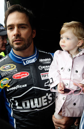 Five-time NASCAR Sprint Cup Series champion Jimmie Johnson holds daughter Genevieve Marie before driver introductions on Sunday at Daytona International Speedway in Daytona Beach, Fla. (Credit: Streeter Lecka/Getty Images)