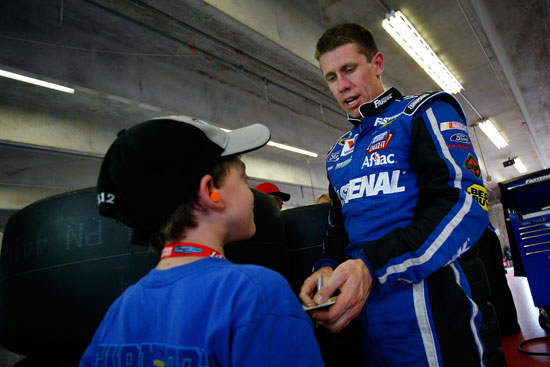 Carl Edwards signs an autograph during practice for the NASCAR Sprint Cup Series Samsung Mobile 500 at Texas Motor Speedway on April 12, 2012 in Fort Worth, Texas. (Credit: Tyler Barrick/Getty Images for NASCAR)