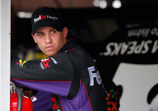 Denny Hamlin, driver of the #11 FedEx Autism Speaks Toyota, stands in the garage area during practice for the NASCAR Sprint Cup Series FedEx 400 benefiting Autism Speaks at Dover International Speedway on June 1, 2012 in Dover, Delaware. (Photo by Rob Carr/Getty Images for NASCAR)