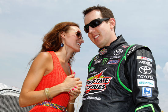 Polesitter Kyle Busch laughs with wife Samantha before the LENOX Industrial Tools 301 at New Hampshire Motor Speedway. (Credit: Todd Warshaw/Getty Images for NASCAR)