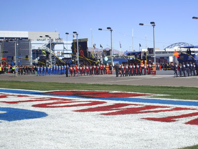 Pit crews line up for the singing of the national anthem at Las Vegas Motor Speedway (photo credit: The Fast and the Fabulous/Valli Hilaire)
