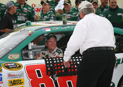 Team owner Rick Hendrick congratulates Dale Earnhardt Jr. after he won the LifeLock 400 at Michigan International Speedway, ending a 76-race winless streak. (Photo Credit: Jerry Markland/Getty Images for NASCAR)