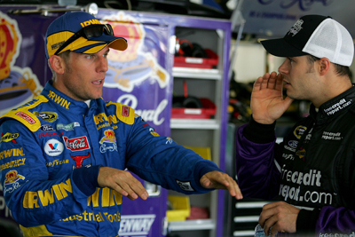 Fellow Ford drivers, Jamie McMurray and David Gilliland, talk about their cars during a break in Saturday's NASCAR Sprint Cup Series practice at Pocono Raceway (Photo Credit: Todd Warshaw/Getty Images)