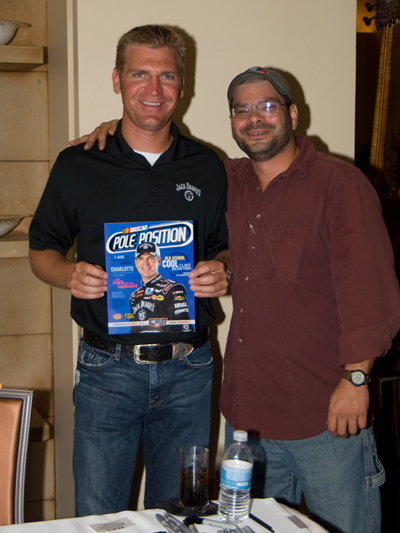 NASCAR Sprint Cup driver Clint Bowyer poses with fan, Al Brown, holding a copy of Pole Position magazine