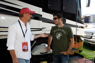 Martin Truex Jr. chats with Kevin Costner, who performed a pre-race concert with his band Modern West. (Photo Credit: Geoff Burke/Getty Images for NASCAR)