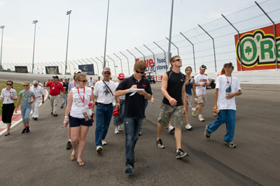 Landon Cassill (L), a native of Cedar Rapids, Ia., and Carl Edwards, who is from Columbia, Mo., lead fans on a charity track walk Saturday at Gateway. Proceeds from the event went to the American Red Cross and its outreach to Midwest flood victims. (Photo Credit: Padraic Major for NASCAR)