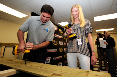 On Friday in the New Hampshire Motor Speedway media center, Jimmie and Chandra Johnson turn the first screws in a project for the Jimmie Johnson Foundation that will provide a home to a family in need. Johnson was second-fastest in Friday's NASCAR Sprint Cup Series practice. (Photo Credit: Rusty Jarrett/Getty Images for NASCAR)