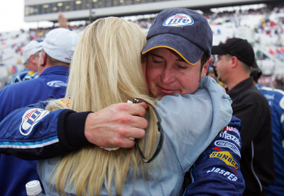 Kurt Busch hugs wife Eva after the Lenox Industrial Tools 301 NASCAR Sprint Cup Series race was declared official on Sunday at New Hampshire Motor Speedway. (Photo Credit: Jim McIsaac/Getty Images)