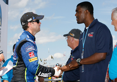 Jimmie Johnson, driver of the No. 48 Lowe's Chevrolet (L) greets grand marshal and former Buffalo Bills tight end Kevin Everett prior to the NASCAR Nationwide Series Zippo 200 at the Watkins Glen International on August 9, 2008 in Watkins Glen, N.Y. (Photo Credit: Geoff Burke/Getty Images for NASCAR)