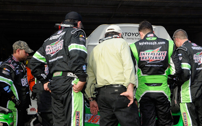 Kyle Busch and the crew of the #18 Interstate Batteries Toyota look at the car in the garage area during the NASCAR Sprint Cup Series Camping World RV 400 at Dover International Speedway on September 21, 2008 in Dover, Delaware. (Photo by Grant Halverson/Getty Images for NASCAR)