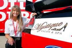 (September 26, 2008): Julie Catalano of Boise, Idaho, kneels next to her company's logo on the No. 99 Office Depot Ford driven by NASCAR star and current Sprint Cup Series point leader Carl Edwards