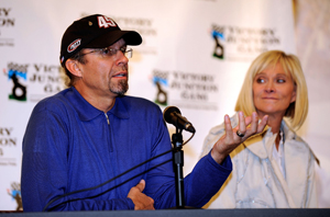 Driver Kyle Petty speaks to the media to announce the construction of a new Victory Junction camp while his wife Pattie looks on prior to practice for the NASCAR Sprint Cup Series Camping World RV 400 at Kansas Speedway. (Photo Credit: Rusty Jarrett/Getty Images for NASCAR)