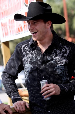 NASCAR Sprint Cup Series driver Scott Speed, "cowboyed up" in his Charlie 1 Horse hat and Panhandle Slim shirt, takes a break after his maiden ride on a mechanical bull in the Fort Worth Stockyards Tuesday, October 21, 2008.  (Photo By Tom Pennington/Getty Images for the Texas Motor Speedway)