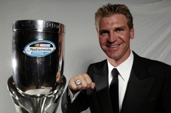 2008 NASCAR Nationwide Series champion driver Clint Bowyer shows off his championship ring and trophy. (Photo Credit: Marc Serota/Getty Images for NASCAR)