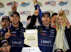 (L-R): Chad Knaus, Jimmie Johnson and Chandra Johnson celebrate their victory in the Checker O'Reilly Auto Parts 500 with the No. 48 team. (Photo Credit: Rusty Jarrett/Getty Images for NASCAR)