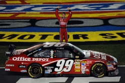 Carl Edwards salutes the fans before doing his trademark back flip after winning Sunday's Dickies 500 at Texas Motor Speedway. The win was Edwards eighth for the 2008 season. (Photo Credit: Ronald Martinez/Getty Images)