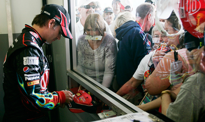 Three-time Daytona 500 winner Jeff Gordon signs autographs for fans during the final NASCAR Sprint Cup Series practice on Saturday for the Daytona 500 at Daytona International Speedway. (Photo Credit: Geoff Burke/Getty Images for NASCAR)