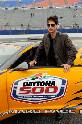 Tom Cruise climbs into the pace car for some practice laps around Daytona International Speedway. Cruise led the Daytona 500 to the green flag in the pace car. (Photo Credit: Rusty Jarrett/Getty Images for NASCAR)