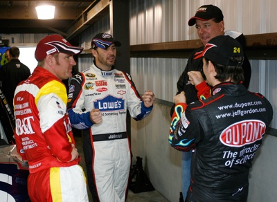 (L-R): Clint Bowyer, Jimmie Johnson, Ron Hornaday Jr. and Jeff Gordon discuss their Martinsville driving styles while waiting for the rain to subside. (Photo Credit: Geoff Burke/Getty Images)