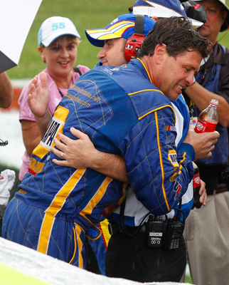 Team owner Michael Waltrip and winning crew chief Rodney Childers hug after the Coca-Cola 600 was called and Reutimann was declared the race winner. The win was the first in the NASCAR Sprint Cup Series for Michael Waltrip Racing. (Photo Credit: Geoff Burke/Getty Images for NASCAR)