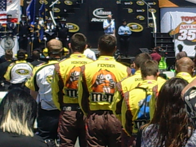 The No. 18 M&M's team listens to the invocation before the Toyota/SaveMart 350 at Infineon Raceway on Sunday, June 21, 2009 (photo credit: The Fast and the Fabulous)