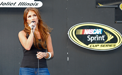 Singer Jessie James performs the National Anthem before Saturday's NASCAR Sprint Cup Series LifeLock.com 400 at Chicagoland Speedway in Joliet, Ill. (Photo Credit: Geoff Burke/Getty Images for NASCAR)