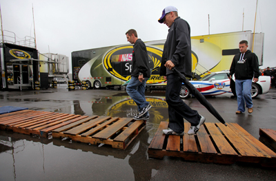 (Left to right) NASCAR Sprint Cup Series drivers Greg Biffle, Jamie McMurray and AJ Allmendinger walk through the garage after the drivers meeting for the Sunoco Red Cross Pennsylvania 500 Sunday at Pocono Raceway in Long Pond, Pa. (Photo Credit: Doug Pensinger/Getty Images)