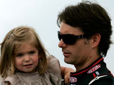 (Right to left) Jeff Gordon, driver of the No. 24 DuPont Chevrolet in the NASCAR Sprint Cup Series, holds his daughter Ella before the Heluva Good! Sour Cream Dips at The Glen on Sunday at Watkins Glen International in Watkins Glen, N.Y. The race was postponed by rain to Monday at noon ET. (Photo Credit: Todd Warshaw/Getty Images for NASCAR)