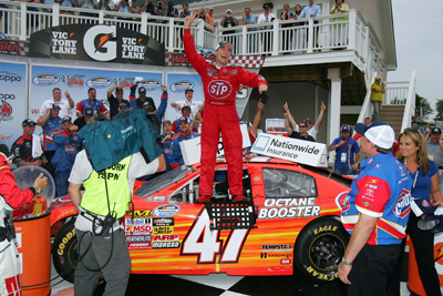 Marcos Ambrose, driver of the No. 47 STP Toyota, celebrates in victory lane after winning the NASCAR Nationwide Series Zippo 200 at Watkins Glen International on Saturday in Watkins Glen, N.Y. (Photo Credit: Todd Warshaw/Getty Images for NASCAR)