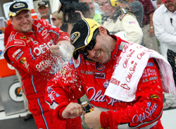 Tony Stewart, driver of the No. 14 Old Spice Chevrolet, gets doused with champagne on Monday after winning the NASCAR Sprint Cup Series Heluva Good! Sour Cream Dips at Watkins Glen International at Watkins Glen, N.Y. (Photo Credit: Chris Graythen/Getty Images)
