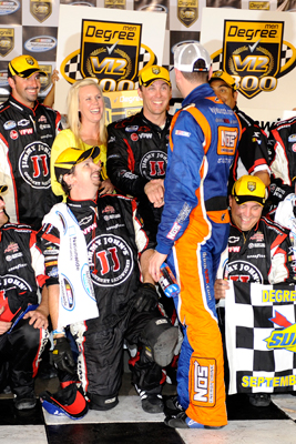 While in Victory Lane with wife DeLana Harvick, crew chief Ernie Cope and the rest of the No. 33 Jimmy John's Cheverolet team, race winner Kevin Harvick is congratulated by race runner-up Kyle Busch, driver of the No. 18 NOS Energy Drink Toyota, after the NASCAR Nationwide Series Degree V12 300 at Atlanta Motor Speedway on Saturday. (Photo Credit: John Harrelson/Getty Images for NASCAR)