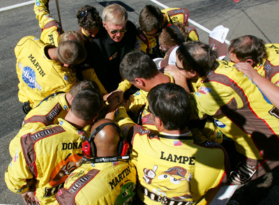 Team owner Joe Gibbs (top, black shirt) talks with the No. 18 M&M's crew before the NASCAR Sprint Cup Series Sylvania 300 at the New Hampshire Motor Speedway on Sunday in Loudon, N.H. (Photo Credit: Todd Warshaw/Getty Images for NASCAR)