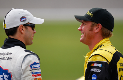 Points leader and three-time Chase for the Sprint Cup champion Jimmie Johnson (left), driver of the No. 48 Lowe's Chevrolet, chats with Kansas native Clint Bowyer (right), driver of the Cheerios/Hamburger Helper Chevrolet, during qualifying Friday for the NASCAR Sprint Cup Series Price Chopper 400 presented by Kraft Foods at the Kansas Speedway on Saturday. (Photo Credit: Geoff Burke/Getty Images for NASCAR)