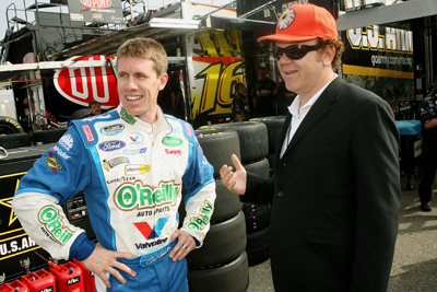 (Right to left) Actor John C. Reilly, and NASCAR Nationwide Series Copart 300 Grand Marshal, talks with NASCAR driver Carl Edwards at Edwards' hauler before the race at Auto Club Speedway on Saturday in Fontana, Calif. (Photo Credit: Stephen Dunn/Getty Images for NASCAR)
