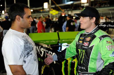 Miami resident Juan Pablo Montoya chats with Ricky Carmichael on pit road before the Ford 200 at Homestead-Miami Speedway. (Photo Credit: John Harrelson/Getty Images for NASCAR)