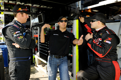 Matt Crafton (center), driver of the No. 88 Menards/McGuire-Nicholas Chevrolet, talks with Brian Scott, driver of the No. 16 Albertson's Toyota (left) and David Gilliland (right), driver of the No. 98 Menards Chevrolet, in the garage area during Thursday's practice for Friday's NASCAR Camping World Truck Series WinStar World Casino 350 at Texas Motor Speedway. Gilliland, who split practice time with Crafton in the No. 98 during the first practice, had the fastest time for most of the final practice (179.766 mph) until Crafton eclipsed his time with a posting of 180.180 mph. (Photo Credit: Rusty Jarrett/Getty Images for NASCAR)