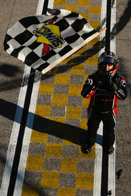 Kyle Busch, driver of the No. 18 Z-Line Designs/WWE Smackdown Toyota, waits as the checkered flag is dropped down to him from the flagstand after winning the NASCAR Nationwide Series O'Reilly Challenge at Texas Motor Speedway in Fort Worth, Texas. This is Busch's fourth victory and fourth straight NASCAR national series races at Texas Motor Speedway. (Photo Credit: Chris Graythen/Getty Images)