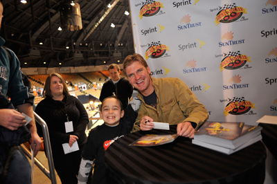 NASCAR Sprint Cup Series driver Clint Bowyer takes a picture with a young fan on Saturday during the Sprint Sound and Speed Fan Festival at Nashville Municipal Auditorium in Nashville, Tenn. (Credit: Grant Halverson/Getty Images for NASCAR)