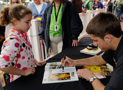 A young fan gets an autograph from NASCAR Sprint Cup Series driver David Ragan on Saturday during NASCAR Preseason Thunder Fan Fest at Daytona International Speedway in Daytona Beach, FL. (Credit: Rusty Jarrett/Getty Images for NASCAR)