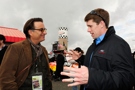 Actor and race Grand Marshall Andy Garcia talks with Carl Edwards, driver of the No. 99 Aflac Ford, in the garage area before Sunday’s NASCAR Sprint Cup Series Auto Club 500 at Auto Club Speedway. (Credit: Rusty Jarrett/Getty Images for NASCAR)