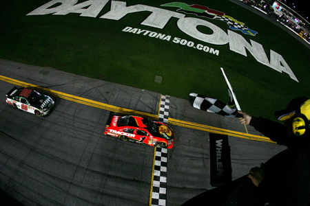 Jamie McMurray crosses the finish line .119 seconds ahead of Dale Earnhardt Jr. to win the Daytona 500 at Daytona International Speedway.(Credit: Todd Warshaw/Getty Images for NASCAR)
