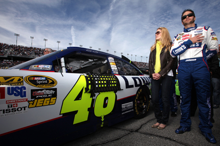 Jimmie Johnson, driver of the No. 48 Lowe's Chevrolet, and his wife Chandra stand next to his car during the national anthem before the first NASCAR Sprint Cup Series Gatorade Duel at Daytona International Speedway on Thursday. (Credit: Jonathan Ferrey/Getty Images for NASCAR)